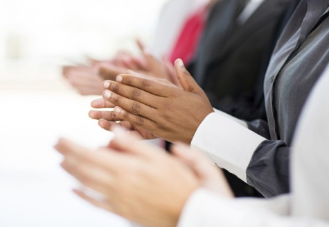 business group applauding for good news