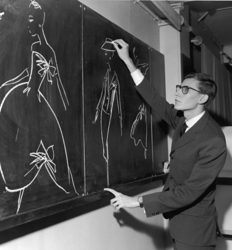 French designer Yves Saint-Laurent uses chalk to sketch fashion designs on a chalkboard in the atelier of the House of Christian Dior, where he had just been named as successor to couturier Christian Dior, Paris, France, November 1957. (Photo by RDA/Getty Images)