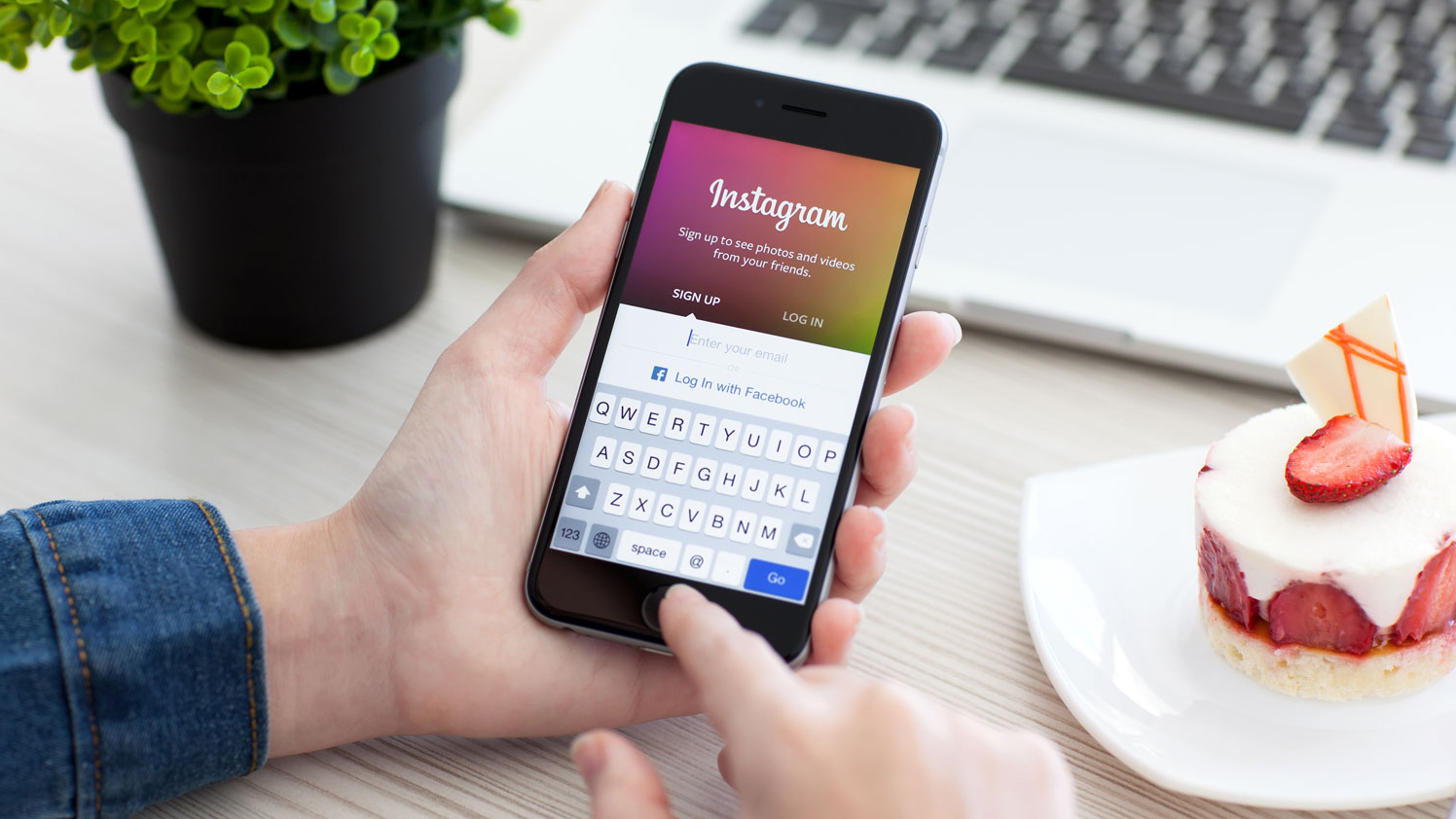 Woman holding iPhone 6 Space Gray with service Instagram